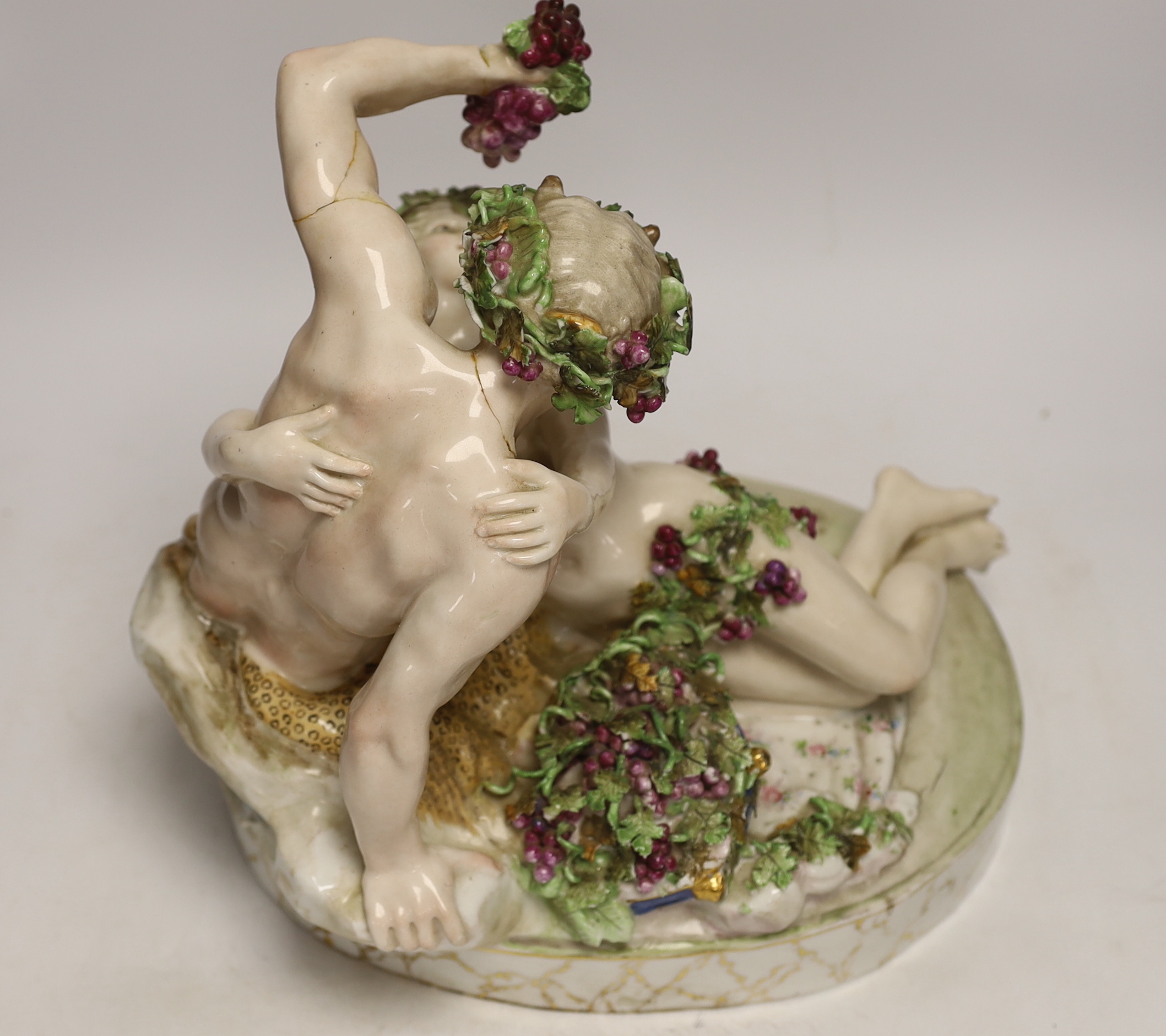 A large German porcelain Bacchus group, pseudo Meissen cross swords mark, 29cm high